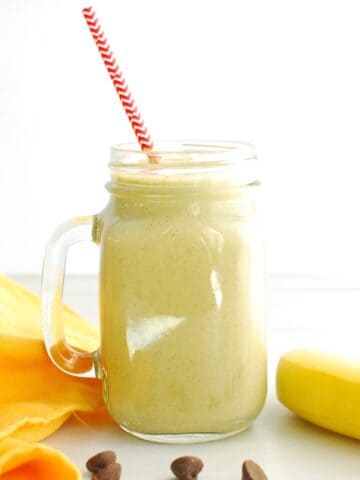 A post workout banana peanut butter chocolate smoothie in a glass jar.