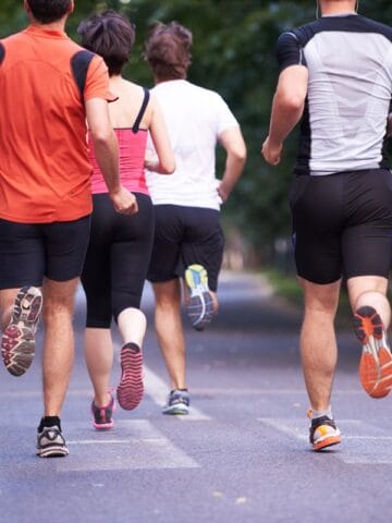 A group of people doing a 5K race.