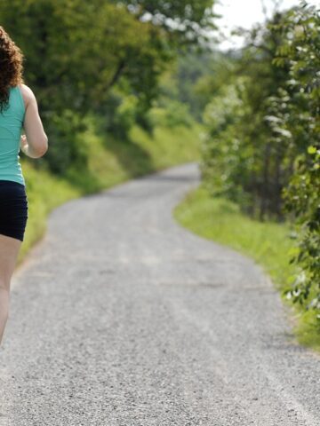 A woman running outside training for a marathon.