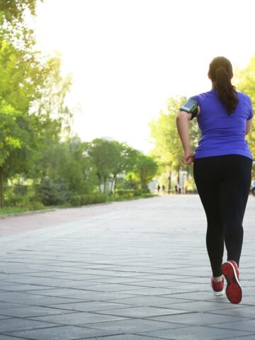 A woman running outside enjoying her time.